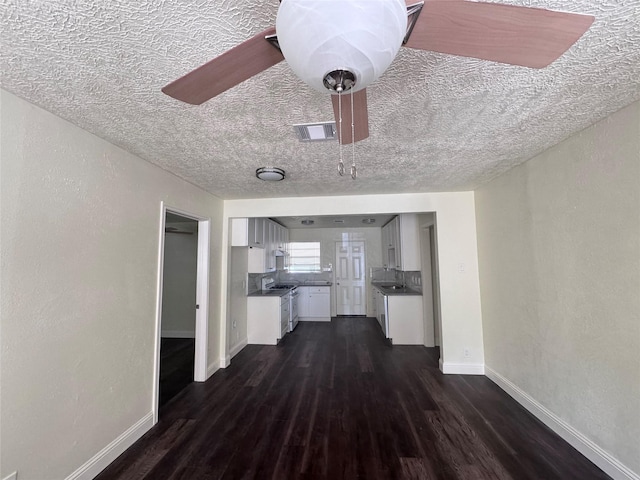 10124 Homestead Rd, Houston, TX 77016 - living room with a textured ceiling and dark wood-type flooring