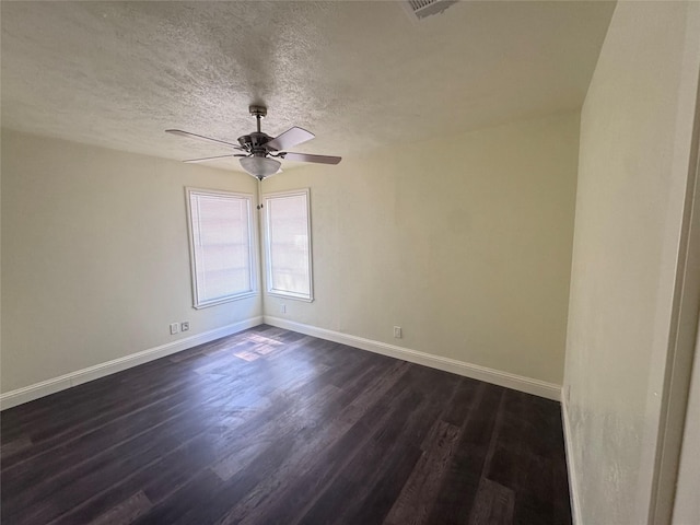 10124 Homestead Rd, Houston, TX 77016 - spare room with dark wood-style flooring, a ceiling fan, and a textured ceiling