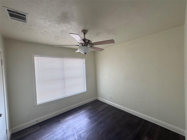 10124 Homestead Rd, Houston, TX 77016 - unfurnished room with dark wood-style floors, a ceiling fan, healthy amount of natural light, and a textured ceiling