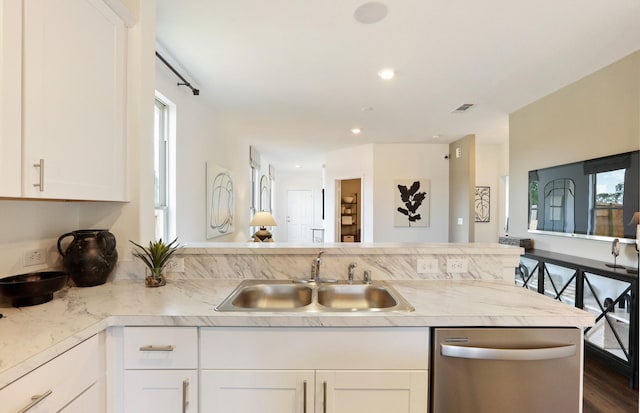 16415 Windy Cove Ct, Conroe, TX 77302 - kitchen featuring stainless steel dishwasher, light countertops, a peninsula, white cabinets, and recessed lighting
