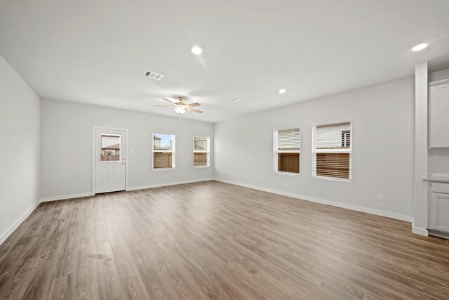 10713 Blocker Ct, Bryan, TX 77801 - unfurnished living room with a ceiling fan, wood finished floors, and recessed lighting