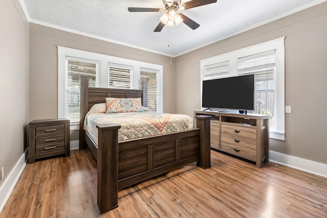 701 W Fawn St, Caldwell, TX 77836 - bedroom with light wood-style floors, crown molding, and a ceiling fan