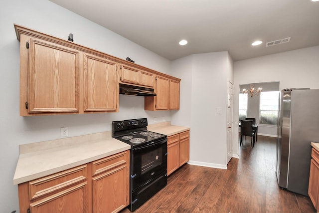 8030 Grow Ln, Houston, TX 77040 - kitchen with black range with electric cooktop, freestanding refrigerator, under cabinet range hood, dark wood-style flooring, and light countertops