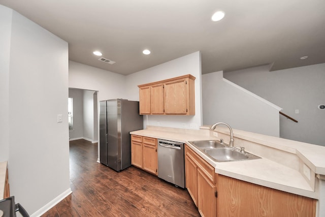 8030 Grow Ln, Houston, TX 77040 - kitchen with appliances with stainless steel finishes, a peninsula, dark wood-type flooring, light countertops, and light brown cabinets