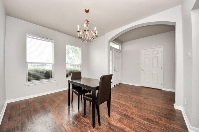 8030 Grow Ln, Houston, TX 77040 - dining area with arched walkways, a chandelier, and dark wood finished floors
