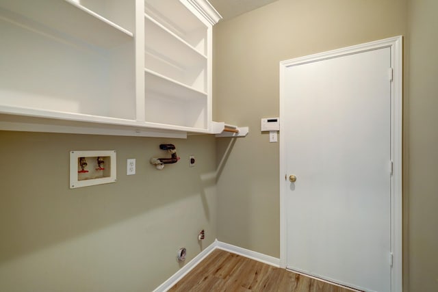 9847 Bestin Ln, Houston, TX 77065 - washroom with hookup for a gas dryer, wood finished floors, washer hookup, and hookup for an electric dryer