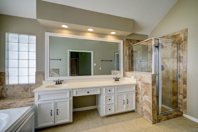 9847 Bestin Ln, Houston, TX 77065 - full bathroom with a shower stall, double vanity, a garden tub, vaulted ceiling, and tile patterned floors