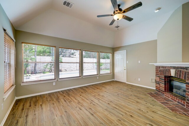 9847 Bestin Ln, Houston, TX 77065 - unfurnished living room with lofted ceiling, a ceiling fan, wood finished floors, and a fireplace