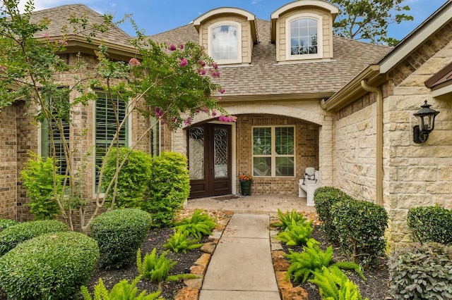 13839 Oak Fair Bnd, Cypress, TX 77429 - view of exterior entry featuring a shingled roof, a porch, and stone siding