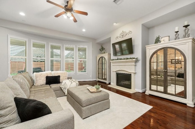 13839 Oak Fair Bnd, Cypress, TX 77429 - living room featuring a glass covered fireplace, ceiling fan, recessed lighting, and dark wood-style flooring
