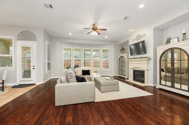 13839 Oak Fair Bnd, Cypress, TX 77429 - living room featuring wood-type flooring, ceiling fan, recessed lighting, and a glass covered fireplace