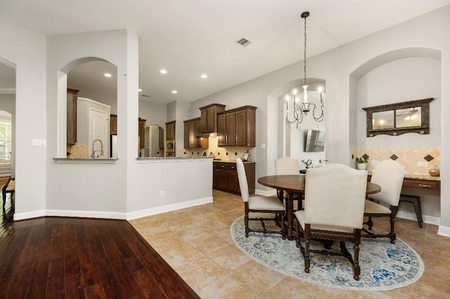 13839 Oak Fair Bnd, Cypress, TX 77429 - dining space with arched walkways, recessed lighting, and a chandelier
