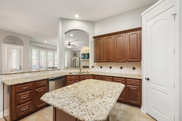 13839 Oak Fair Bnd, Cypress, TX 77429 - kitchen featuring dishwasher, backsplash, light stone counters, a peninsula, and recessed lighting