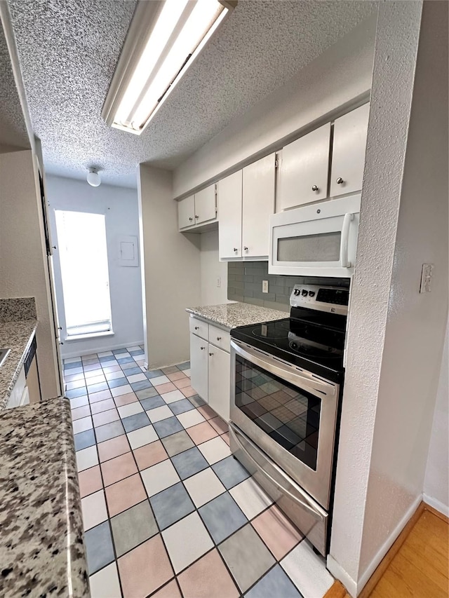 260 El Dorado Blvd Unit 2608, Houston, TX 77598 - kitchen featuring white microwave, stainless steel electric range, white cabinetry, backsplash, and a textured ceiling