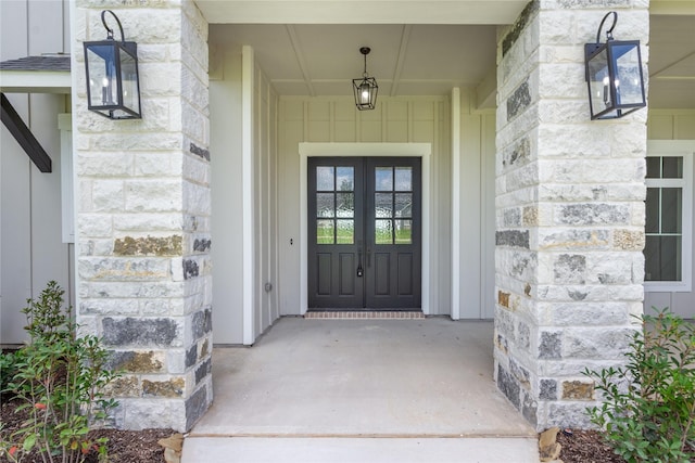 1430 Bluebonnet Ridge Dr, Chappell Hill, TX 77426 - view of exterior entry with french doors, stone siding, and board and batten siding