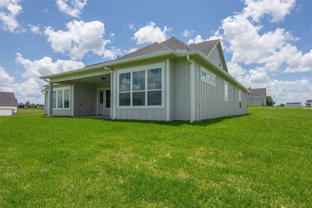 1430 Bluebonnet Ridge Dr, Chappell Hill, TX 77426 - rear view of house featuring board and batten siding, a yard, and a shingled roof