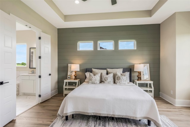 1430 Bluebonnet Ridge Dr, Chappell Hill, TX 77426 - bedroom with an accent wall, wood walls, ensuite bathroom, and multiple windows