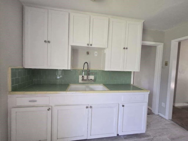 822 Woodhue St, Channelview, TX 77530 - kitchen with tile countertops, white cabinets, backsplash, and light wood finished floors