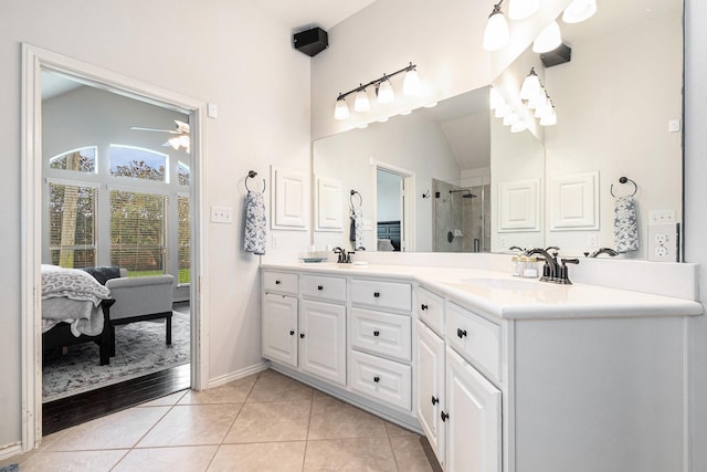 14730 Yellow Begonia Dr, Cypress, TX 77433 - ensuite bathroom featuring double vanity, a shower stall, ceiling fan, tile patterned floors, and vaulted ceiling
