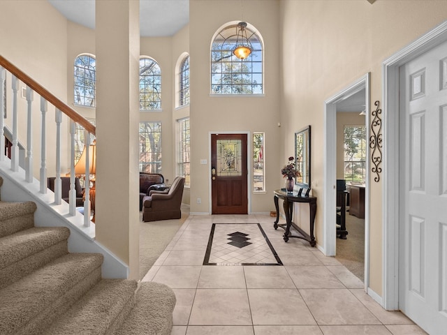 1410 Juniper Ln, Seabrook, TX 77586 - entrance foyer featuring light tile patterned flooring, stairs, and a high ceiling