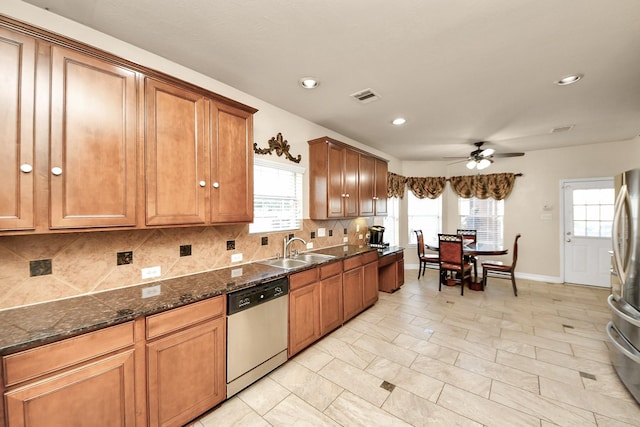 20718 Mansfield Bay Ln, Richmond, TX 77407 - kitchen featuring appliances with stainless steel finishes, ceiling fan, decorative backsplash, plenty of natural light, and recessed lighting