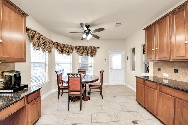 20718 Mansfield Bay Ln, Richmond, TX 77407 - dining room featuring a ceiling fan and baseboards