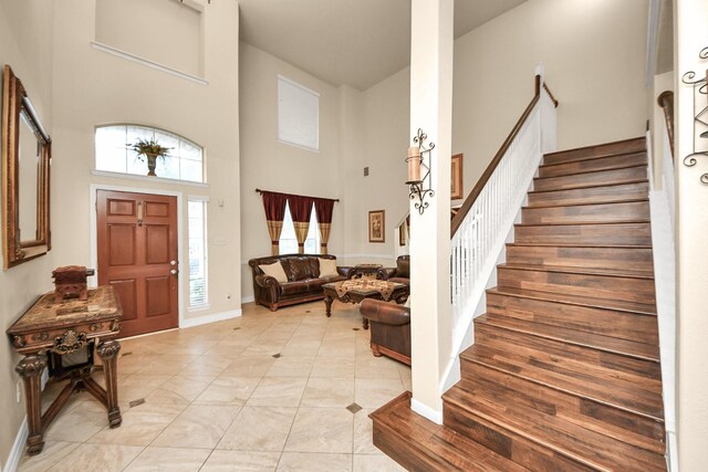 20718 Mansfield Bay Ln, Richmond, TX 77407 - foyer entrance with a towering ceiling, stairway, and light tile patterned floors