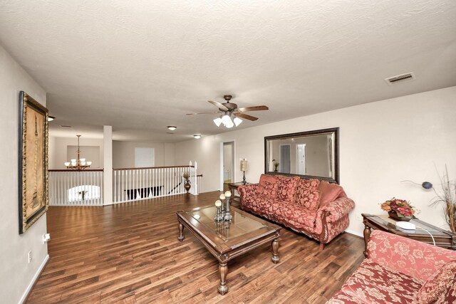 20718 Mansfield Bay Ln, Richmond, TX 77407 - living room featuring a chandelier, wood finished floors, ceiling fan, and a textured ceiling