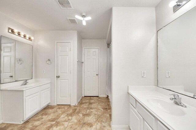 20718 Mansfield Bay Ln, Richmond, TX 77407 - bathroom featuring two vanities and baseboards