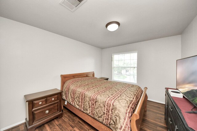20718 Mansfield Bay Ln, Richmond, TX 77407 - bedroom featuring dark wood-style flooring and baseboards