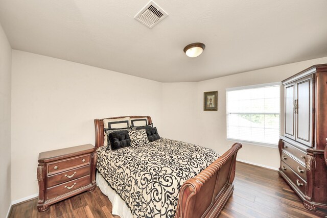 20718 Mansfield Bay Ln, Richmond, TX 77407 - bedroom with baseboards and dark wood finished floors