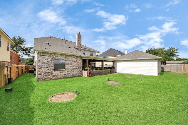 20718 Mansfield Bay Ln, Richmond, TX 77407 - back of property featuring brick siding, a fenced backyard, a chimney, and a shingled roof