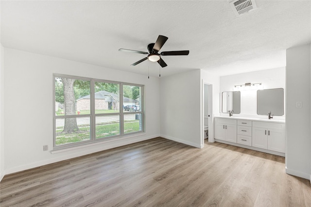 7215 Daylight Ln, Houston, TX 77095 - unfurnished bedroom featuring light wood-type flooring, connected bathroom, and ceiling fan