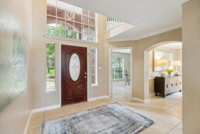 17426 Little Riata Dr, Houston, TX 77095 - entrance foyer featuring tile patterned flooring, arched walkways, and crown molding