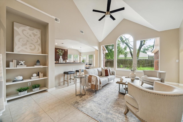 17426 Little Riata Dr, Houston, TX 77095 - living area with a ceiling fan, light tile patterned floors, arched walkways, high vaulted ceiling, and built in features