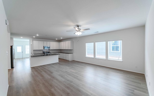 25035 Apricot Ct, Montgomery, TX 77316 - unfurnished living room with a ceiling fan, recessed lighting, and light wood finished floors
