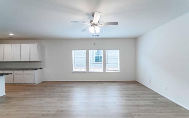 25035 Apricot Ct, Montgomery, TX 77316 - unfurnished living room featuring ceiling fan and light wood-style flooring