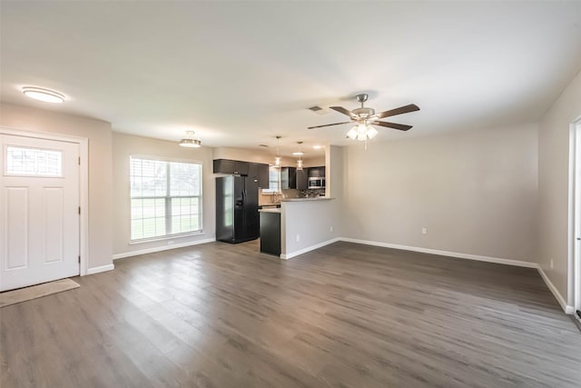 10327 Collingswood Rd, La Porte, TX 77571 - unfurnished living room with dark wood-type flooring and a ceiling fan