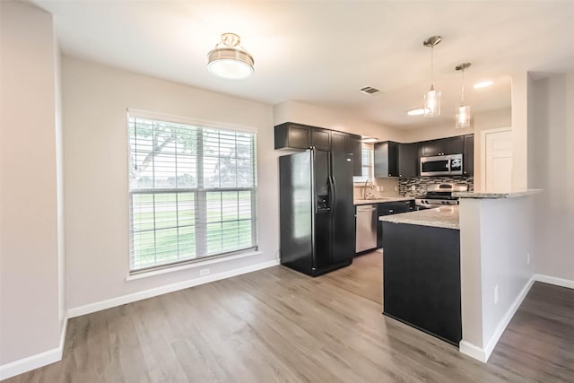 10327 Collingswood Rd, La Porte, TX 77571 - kitchen featuring stainless steel appliances, healthy amount of natural light, and light wood-style floors