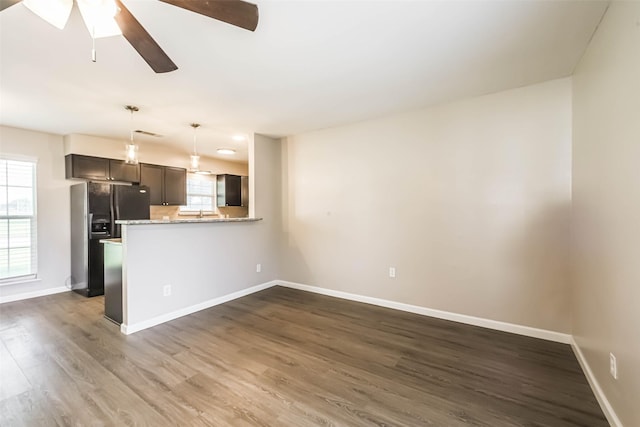 10327 Collingswood Rd, La Porte, TX 77571 - unfurnished living room featuring dark wood-type flooring and a ceiling fan