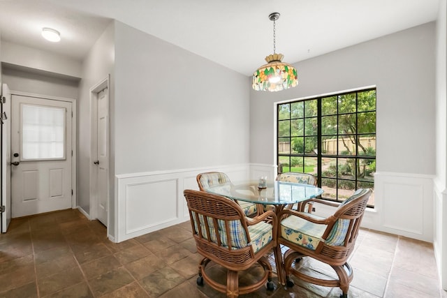 5 Hartwick Ct, Conroe, TX 77304 - dining space featuring a decorative wall and a wainscoted wall