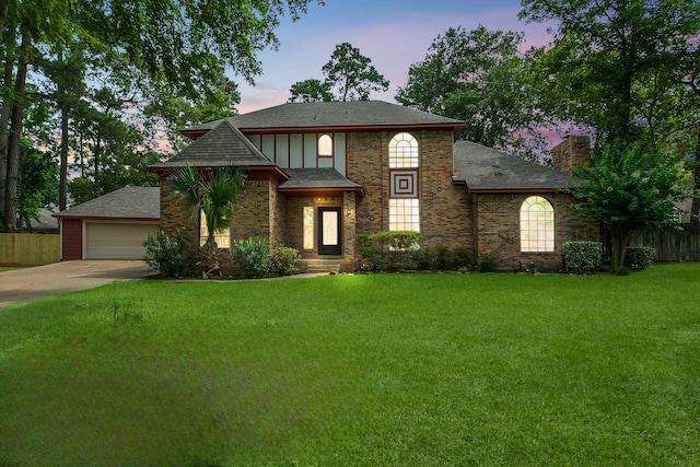 5 Hartwick Ct, Conroe, TX 77304 - view of front facade with roof with shingles, a chimney, brick siding, and a detached garage