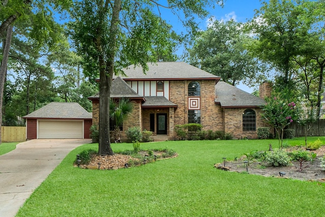 5 Hartwick Ct, Conroe, TX 77304 - english style home featuring a detached garage, brick siding, a chimney, roof with shingles, and an outbuilding