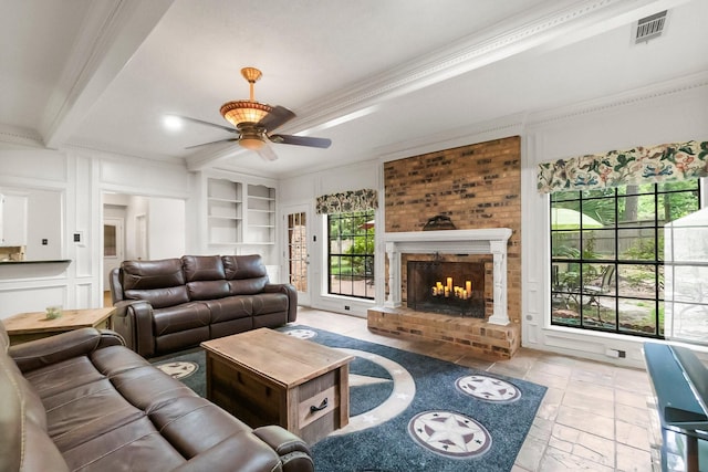 5 Hartwick Ct, Conroe, TX 77304 - living room featuring a ceiling fan, ornamental molding, a fireplace, built in features, and healthy amount of natural light