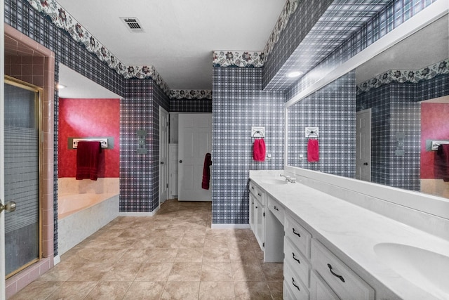 5 Hartwick Ct, Conroe, TX 77304 - bathroom featuring wallpapered walls, double vanity, a garden tub, and a stall shower