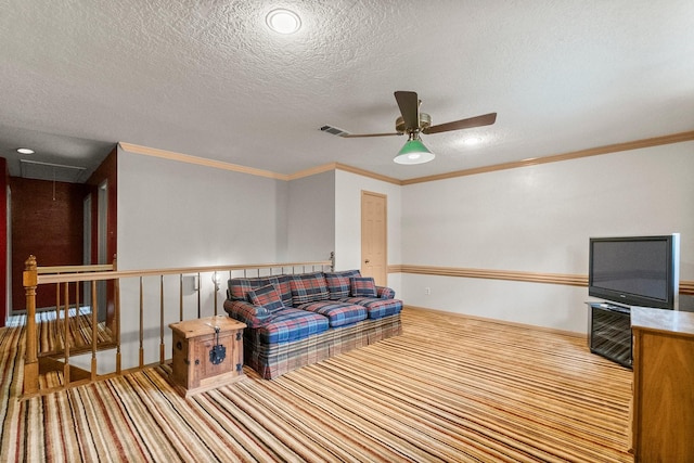5 Hartwick Ct, Conroe, TX 77304 - living area featuring attic access, carpet flooring, ceiling fan, a textured ceiling, and ornamental molding