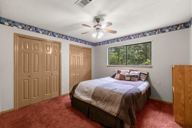 5 Hartwick Ct, Conroe, TX 77304 - carpeted bedroom with two closets, a textured ceiling, and ceiling fan