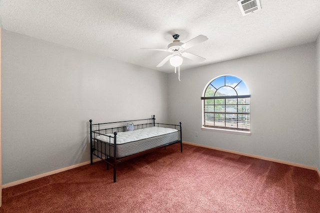 5 Hartwick Ct, Conroe, TX 77304 - carpeted bedroom featuring a ceiling fan and a textured ceiling
