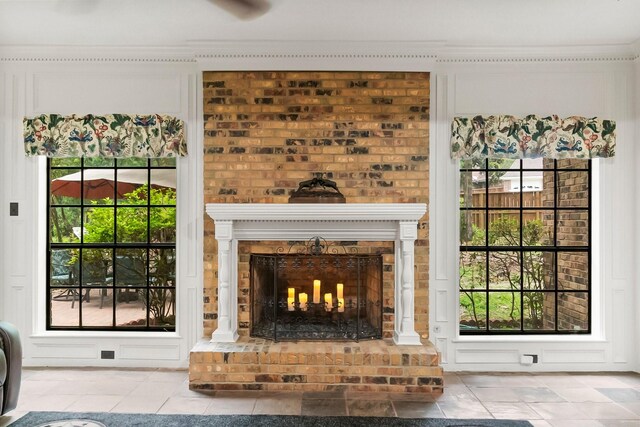 5 Hartwick Ct, Conroe, TX 77304 - unfurnished living room with a fireplace, crown molding, and tile patterned floors