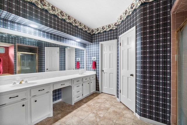 5 Hartwick Ct, Conroe, TX 77304 - bathroom with wallpapered walls, double vanity, a shower with door, and tile patterned floors